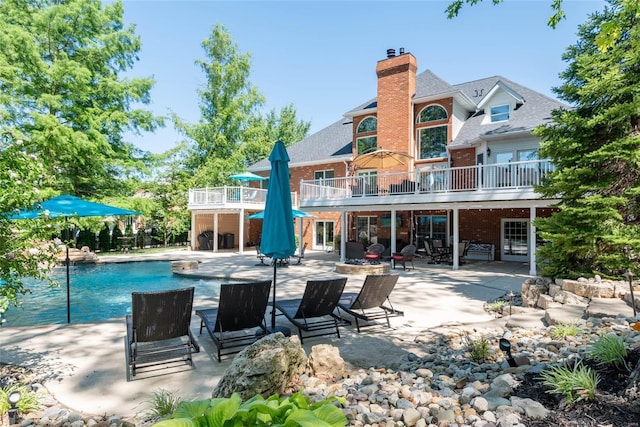 rear view of property with a patio area and a swimming pool side deck