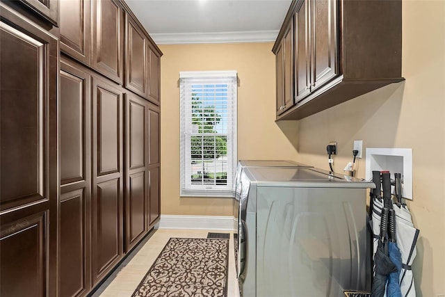 laundry area with washer and dryer, crown molding, and cabinets