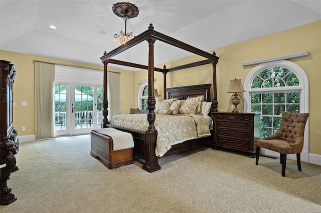 bedroom featuring an inviting chandelier, light colored carpet, and access to outside