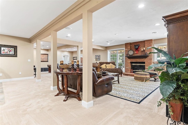 living room featuring light colored carpet and a fireplace