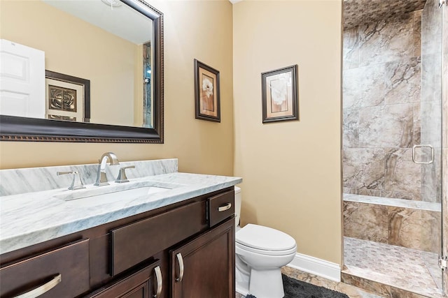 bathroom featuring toilet, walk in shower, and vanity