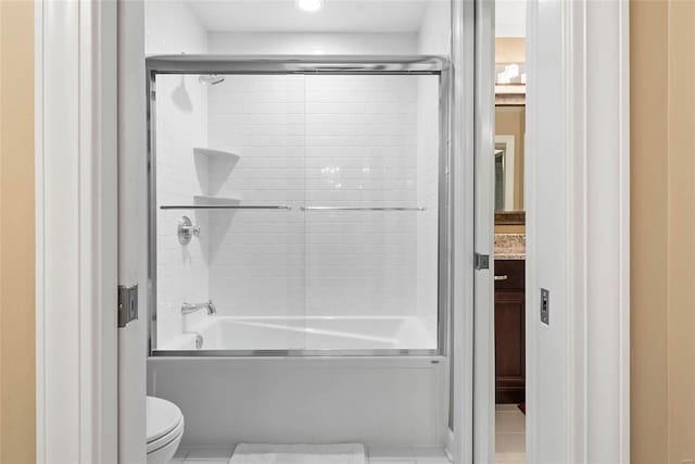 full bathroom with toilet, bath / shower combo with glass door, and vanity