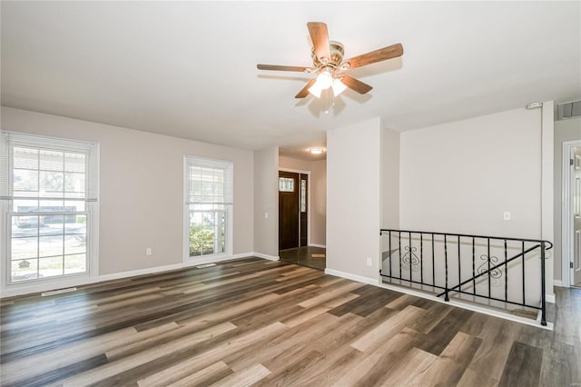 empty room with ceiling fan and wood-type flooring