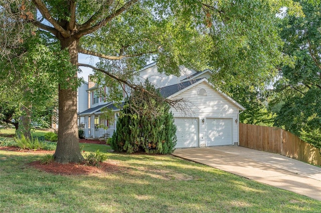 view of front of property with driveway, an attached garage, a front lawn, and fence