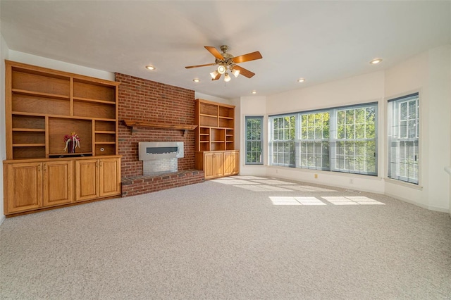 unfurnished living room with recessed lighting, baseboards, a brick fireplace, and carpet flooring