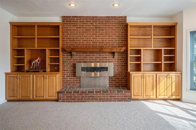 unfurnished living room with recessed lighting, carpet floors, and a fireplace