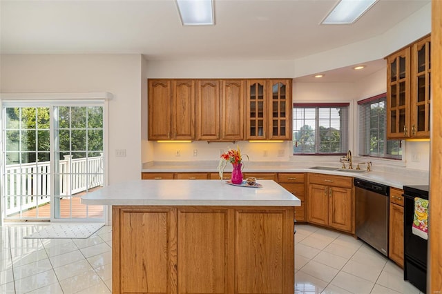 kitchen featuring light tile patterned floors, a sink, light countertops, stainless steel dishwasher, and brown cabinets