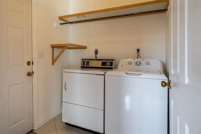 washroom with light tile patterned flooring, laundry area, and independent washer and dryer