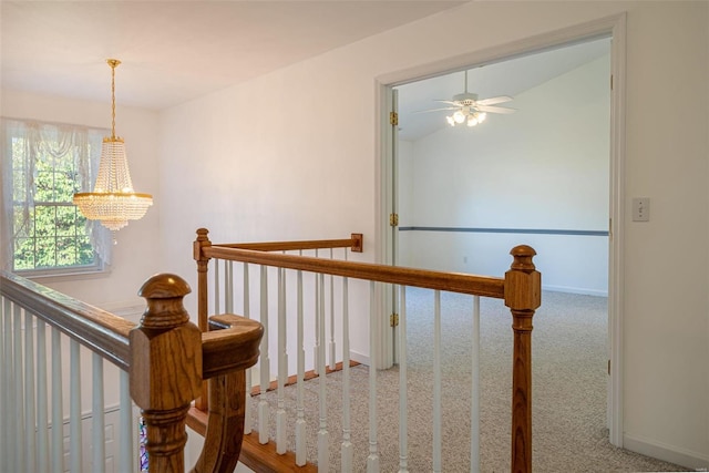 stairs featuring baseboards, a notable chandelier, carpet flooring, and vaulted ceiling