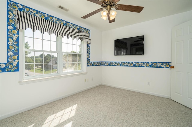 unfurnished room with visible vents, ceiling fan, and baseboards