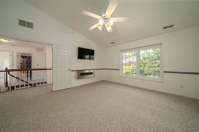 empty room featuring visible vents, high vaulted ceiling, baseboards, and carpet floors