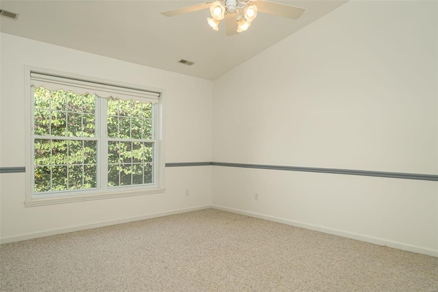 carpeted empty room with visible vents, baseboards, a ceiling fan, and vaulted ceiling