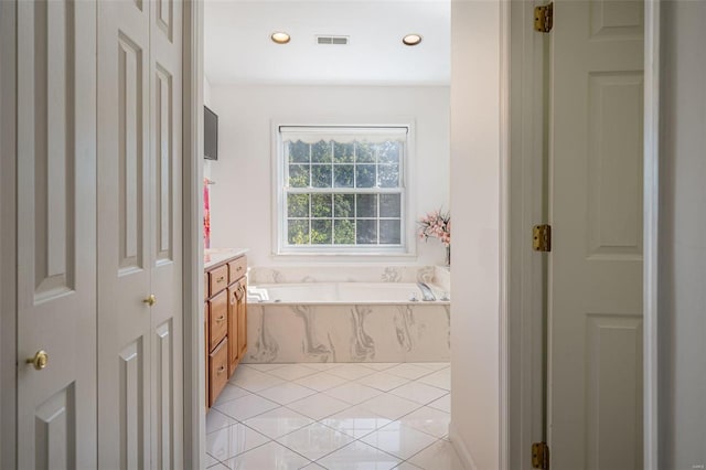 bathroom featuring visible vents, a garden tub, recessed lighting, tile patterned floors, and vanity