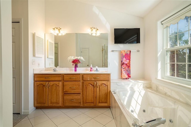 bathroom with double vanity, lofted ceiling, a tub with jets, and tile patterned flooring