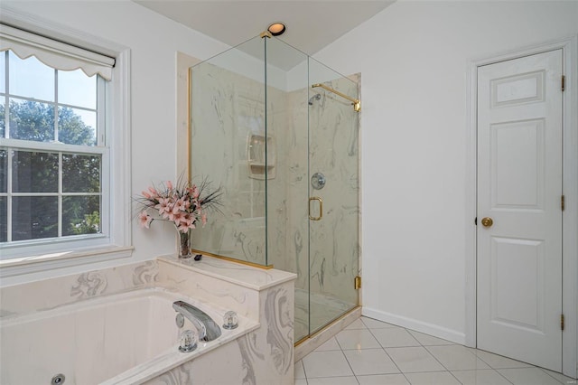 bathroom featuring a wealth of natural light, a marble finish shower, tile patterned floors, and a bath