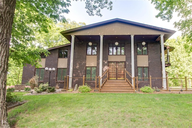 view of front facade with a front lawn and brick siding