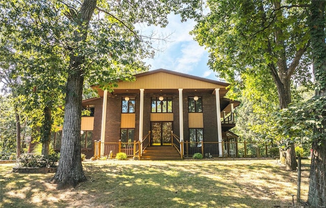 exterior space featuring brick siding, a porch, and fence