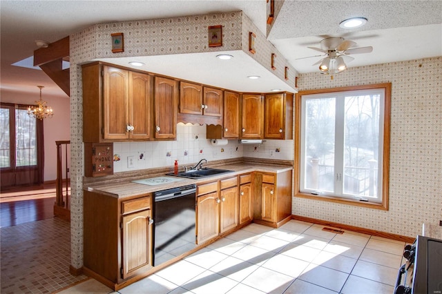 kitchen featuring a textured ceiling, ceiling fan with notable chandelier, dishwasher, light tile patterned floors, and sink