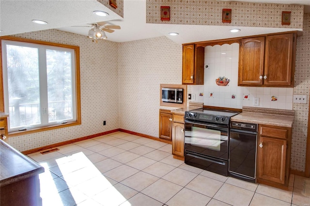 kitchen featuring ceiling fan, light tile patterned floors, black range with electric stovetop, and a textured ceiling