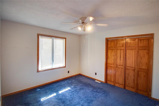 unfurnished bedroom with a closet, a textured ceiling, ceiling fan, and carpet