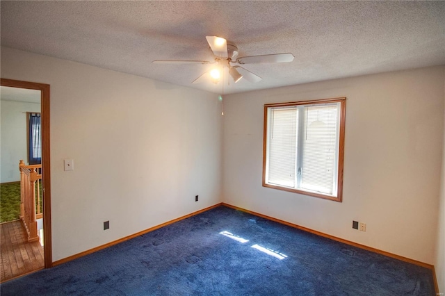 carpeted empty room featuring ceiling fan and a textured ceiling