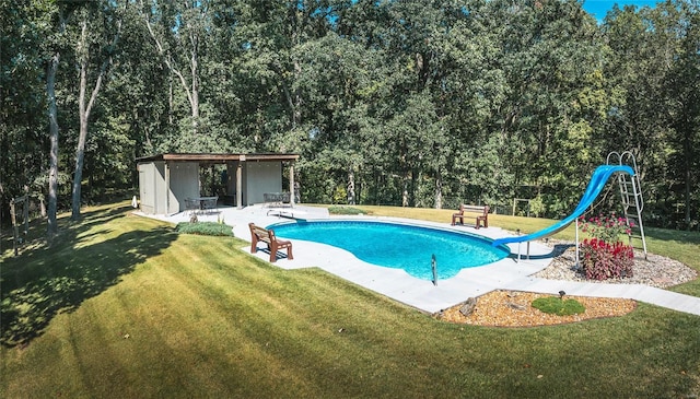 view of swimming pool featuring a playground, a yard, a water slide, a diving board, and a patio