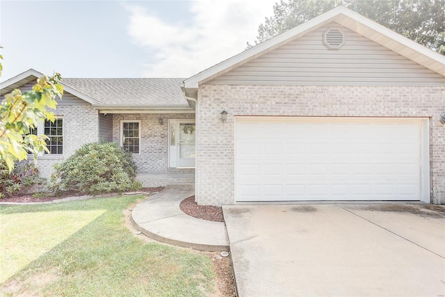 single story home with a garage and a front lawn