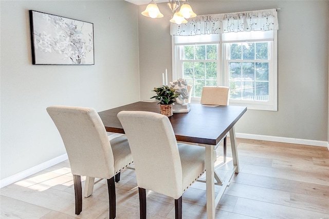 dining room featuring an inviting chandelier and light hardwood / wood-style flooring