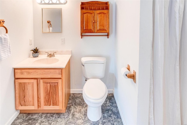 bathroom with toilet and vanity