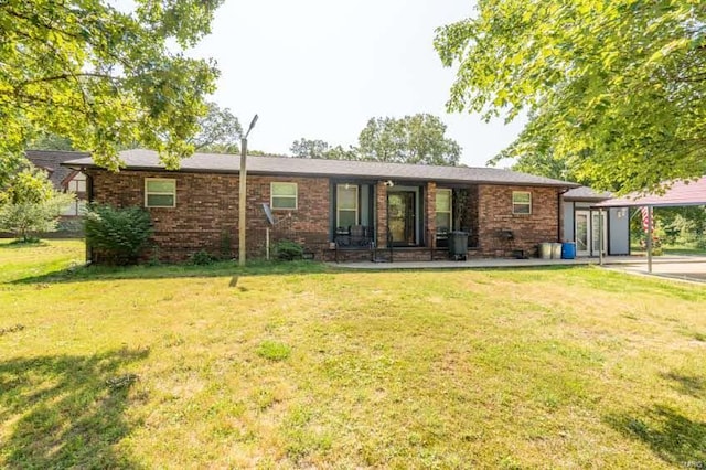 single story home with a front lawn and a carport