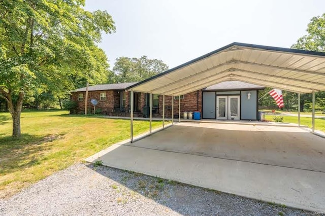 view of vehicle parking with a carport and a yard