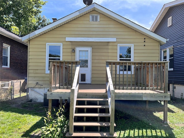 back of house featuring a yard and a deck