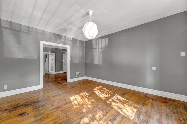 unfurnished room with wood-type flooring