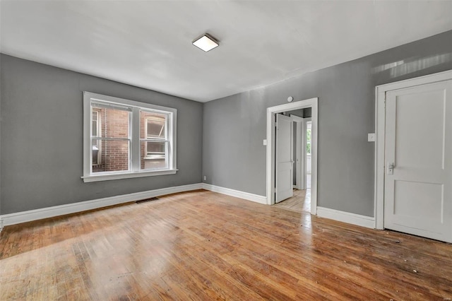 unfurnished room with light hardwood / wood-style floors