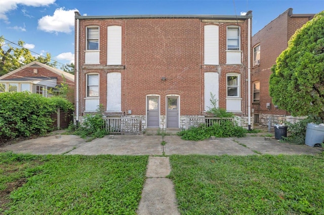 townhome / multi-family property featuring a front lawn