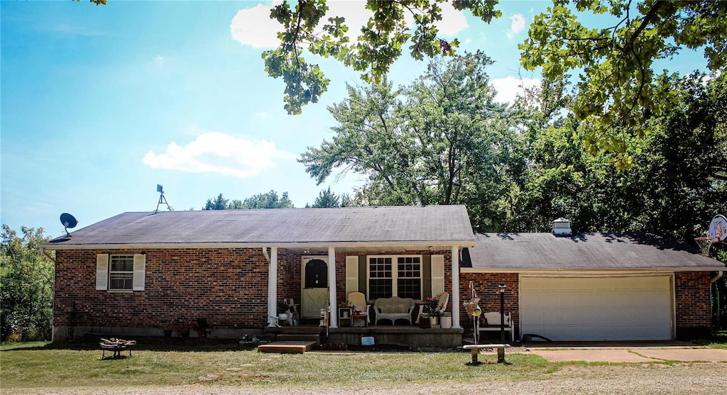 single story home with a garage and a front lawn