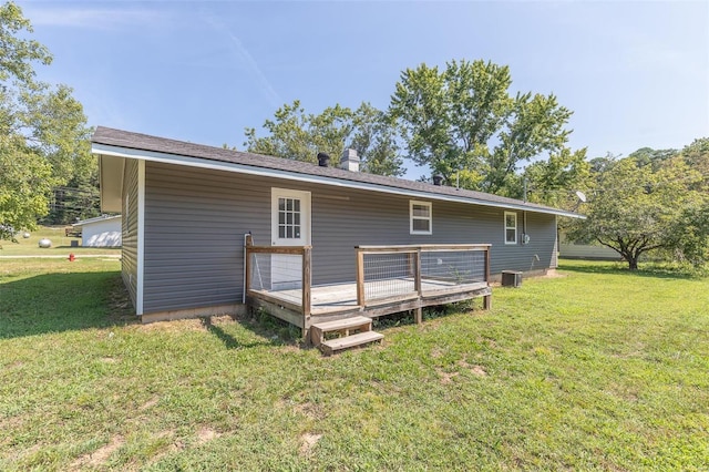 back of property featuring central air condition unit, a deck, and a yard