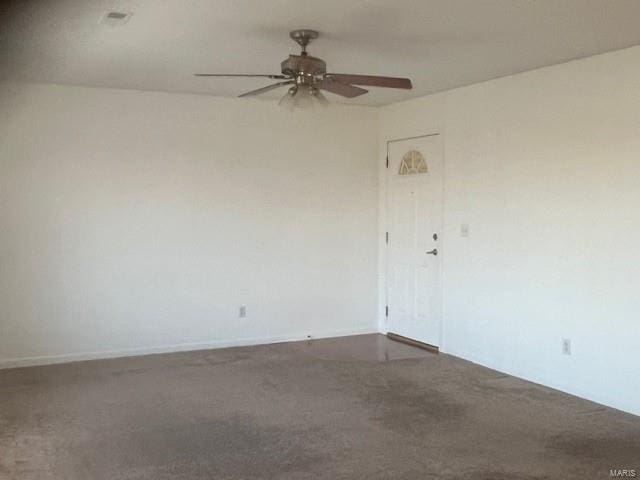 carpeted spare room with ceiling fan