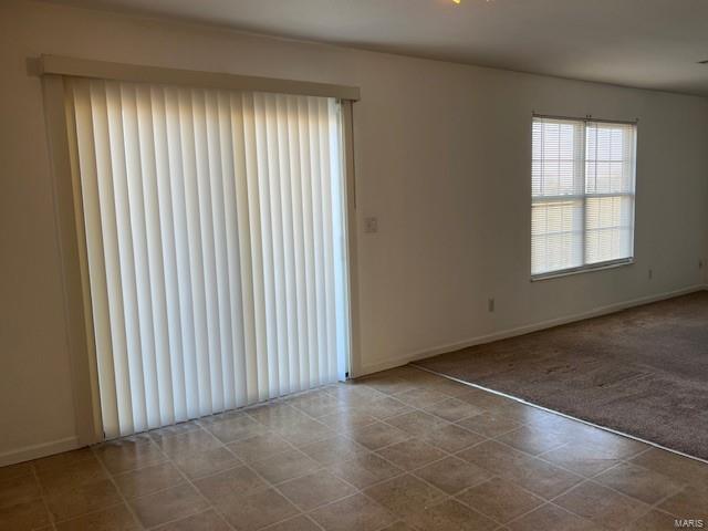 empty room featuring light carpet