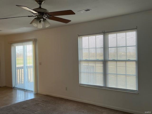 unfurnished room with carpet floors and ceiling fan