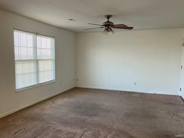 carpeted spare room with ceiling fan