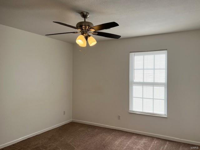 carpeted empty room featuring ceiling fan