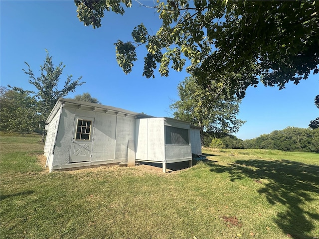 view of outbuilding featuring a yard