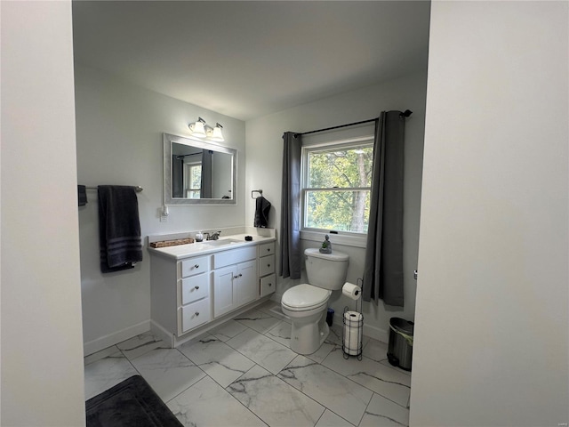 bathroom featuring tile patterned flooring, toilet, and vanity