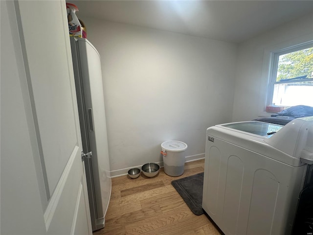 washroom featuring light hardwood / wood-style floors and washer / clothes dryer