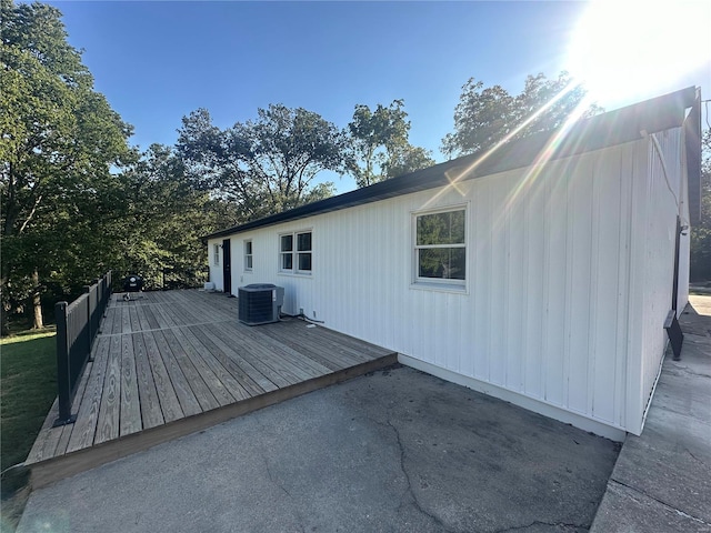 view of side of home with a deck and central air condition unit