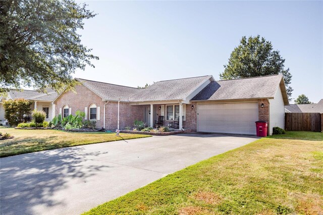 single story home featuring a front yard and a garage