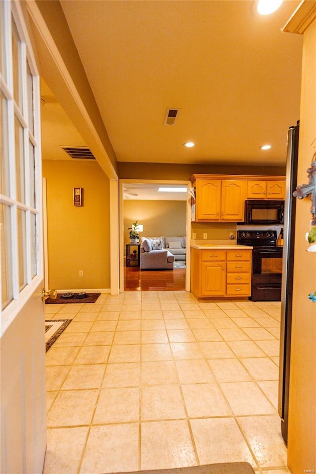 kitchen with visible vents, recessed lighting, black appliances, and light countertops