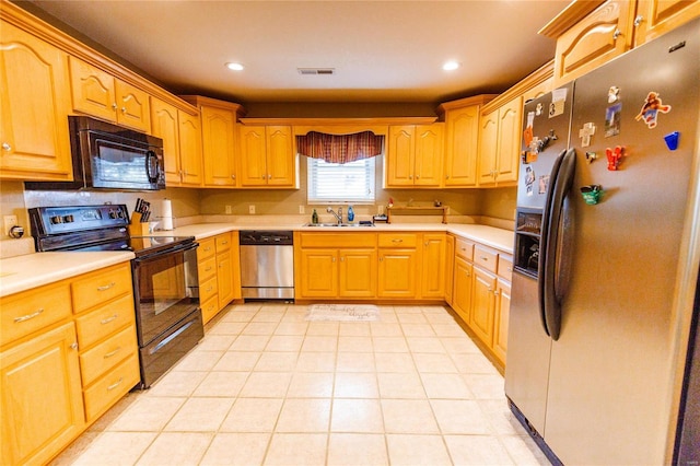 kitchen with visible vents, recessed lighting, a sink, black appliances, and light countertops