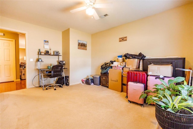 interior space with baseboards, visible vents, carpet floors, and ceiling fan